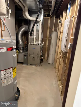 a view of storage and utility room with refrigerator and washer