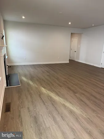 an empty room with wooden floor