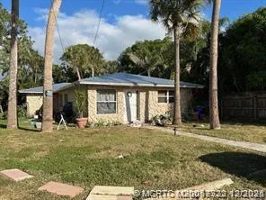 a view of a house with backyard sitting area and garden