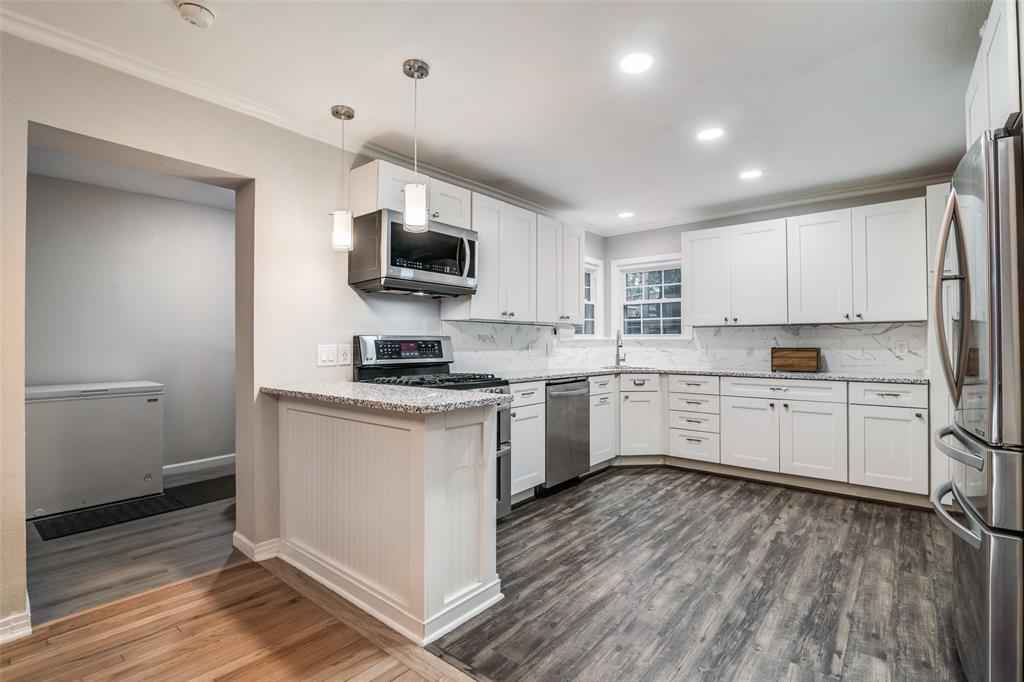 3714 Valley Ridge Road Dallas, TX 75220 - Photo 12 of 26 a kitchen with a white cabinets and wooden floor