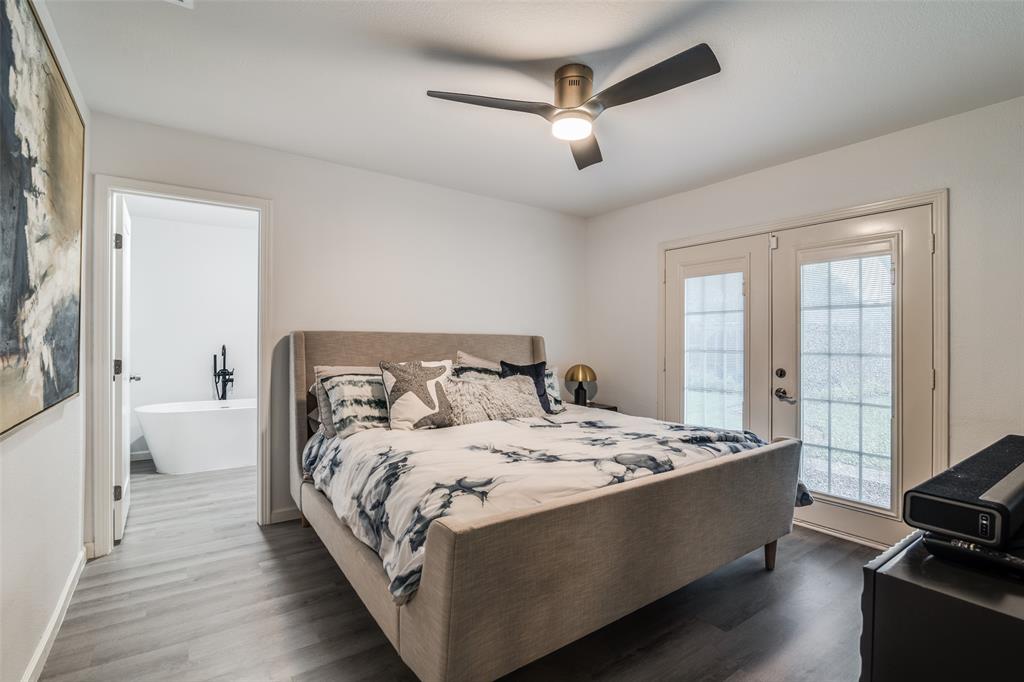 3714 Valley Ridge Road Dallas, TX 75220 - Photo 18 of 26 a large bed sitting in a bedroom next to a window