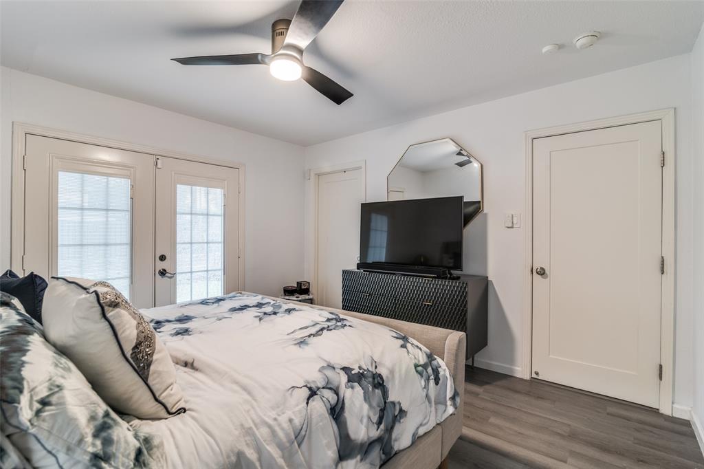 3714 Valley Ridge Road Dallas, TX 75220 - Photo 19 of 26 a bedroom with a bed and wooden floor