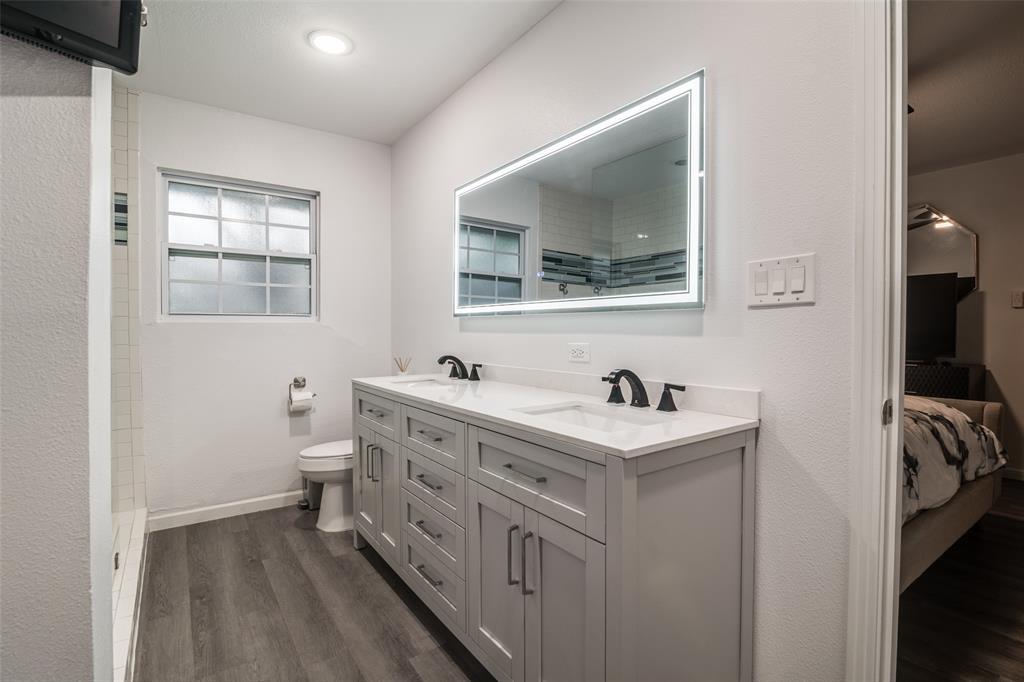 3714 Valley Ridge Road Dallas, TX 75220 - Photo 20 of 26 a bathroom with a sink and a toilet
