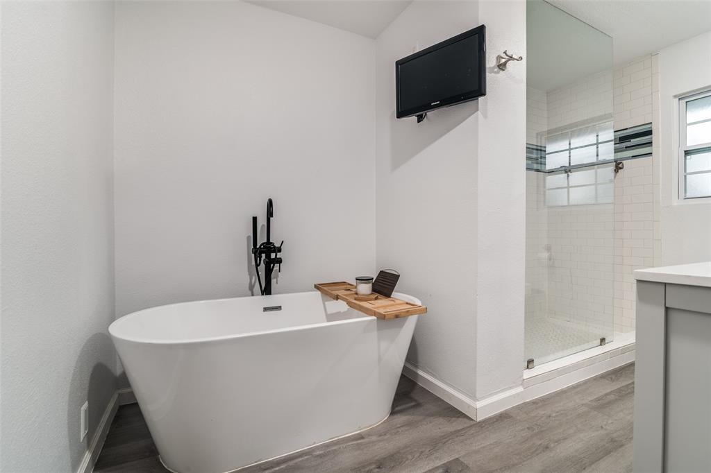3714 Valley Ridge Road Dallas, TX 75220 - Photo 21 of 26 a white bath tub sitting in a bathroom