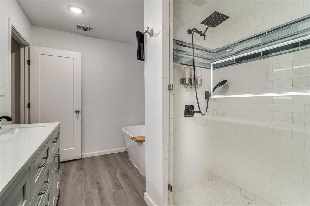 3714 Valley Ridge Road Dallas, TX 75220 - Photo 22 of 26 a bathroom with a sink a toilet and shower