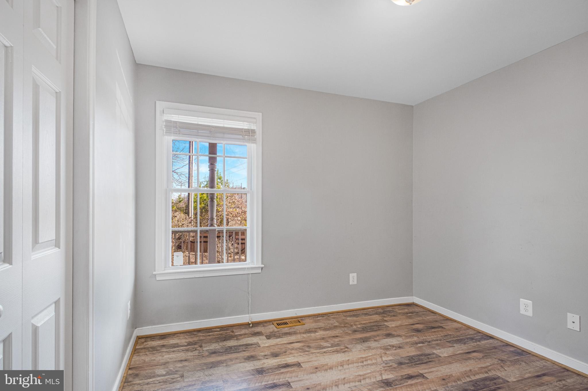 12254 Birkdale Road Ruther Glen, VA 22546 - Photo 13 of 68 a view of an empty room with wooden floor and a window