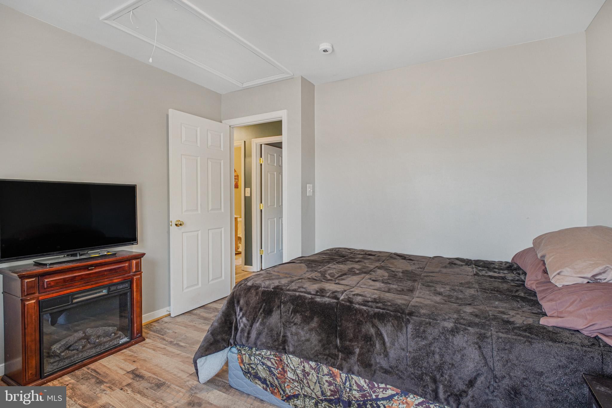 12254 Birkdale Road Ruther Glen, VA 22546 - Photo 19 of 68 a bedroom with a bed and a flat screen tv