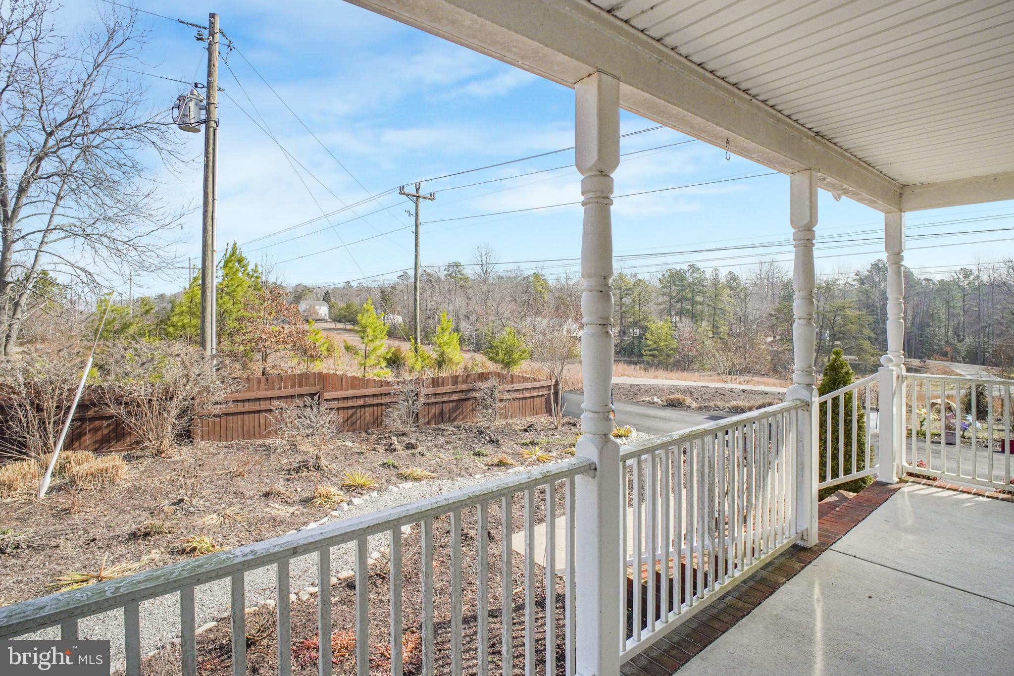 12254 Birkdale Road Ruther Glen, VA 22546 - Photo 25 of 68 a view of a balcony with floor to ceiling window and wooden fence