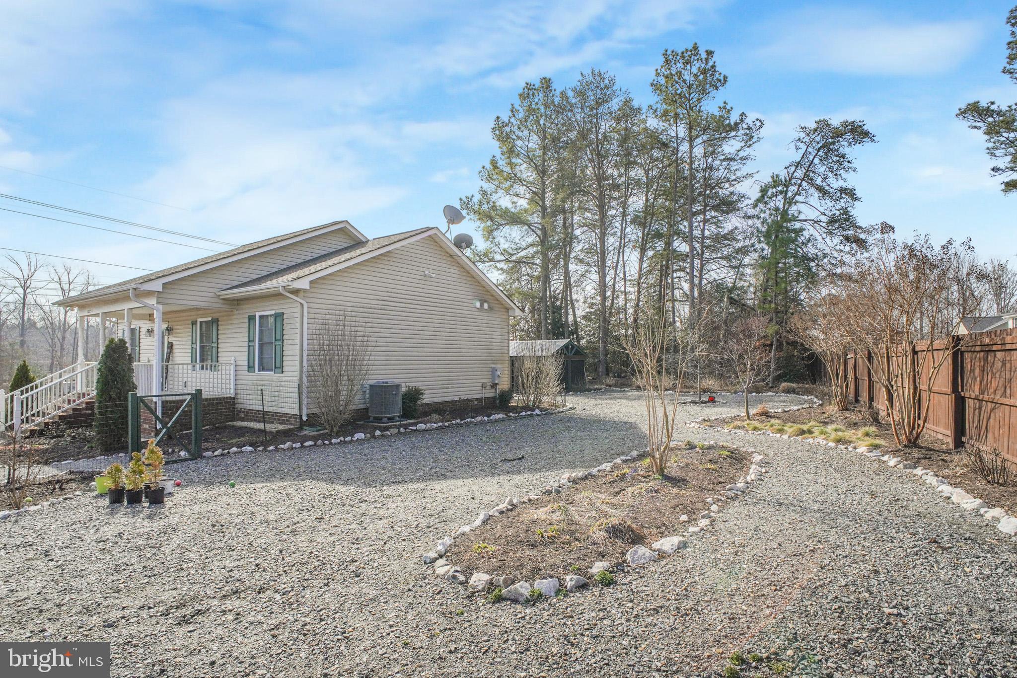 12254 Birkdale Road Ruther Glen, VA 22546 - Photo 30 of 68 a backyard of a house with table and chairs