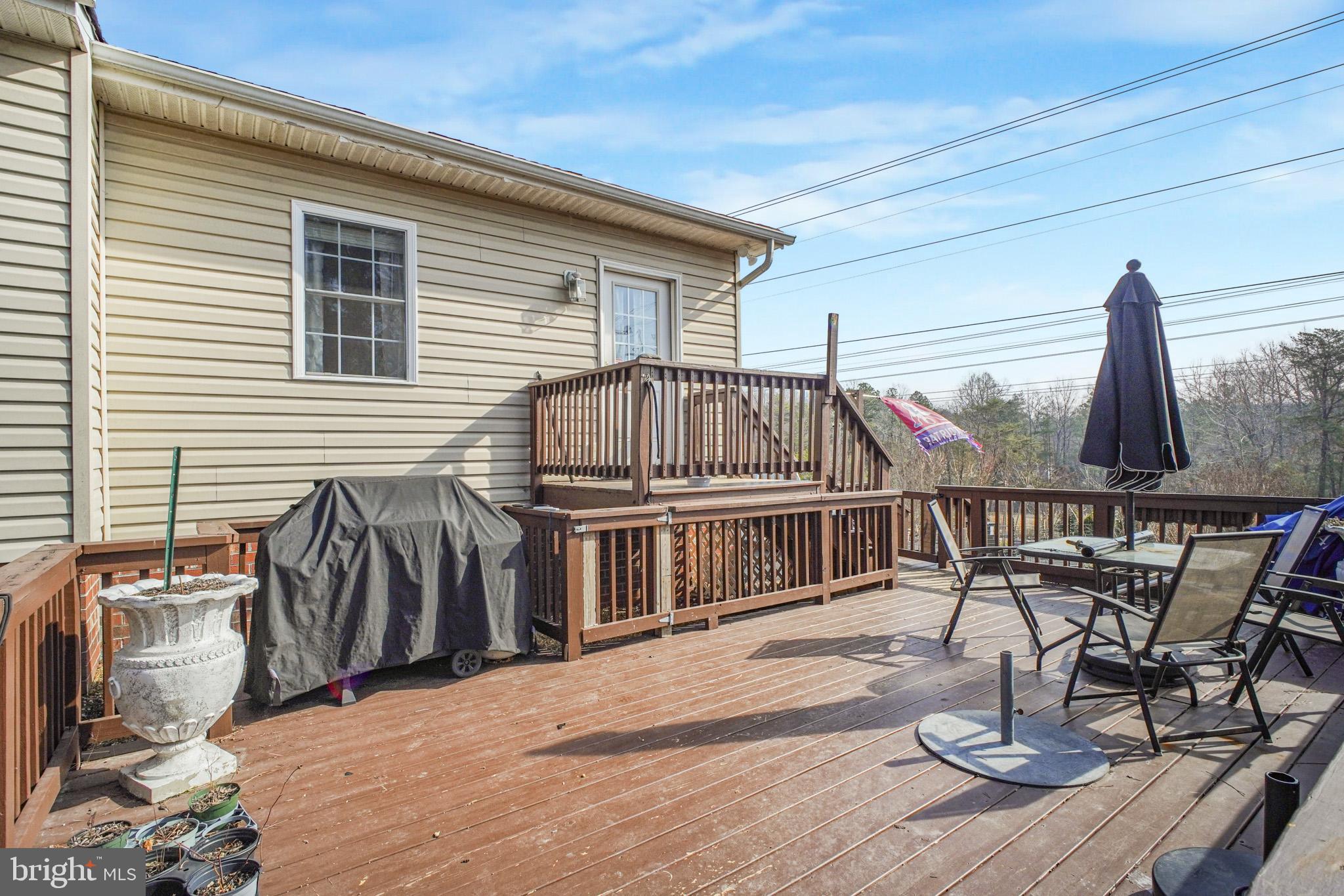 12254 Birkdale Road Ruther Glen, VA 22546 - Photo 38 of 68 a view of a chairs and table on the deck