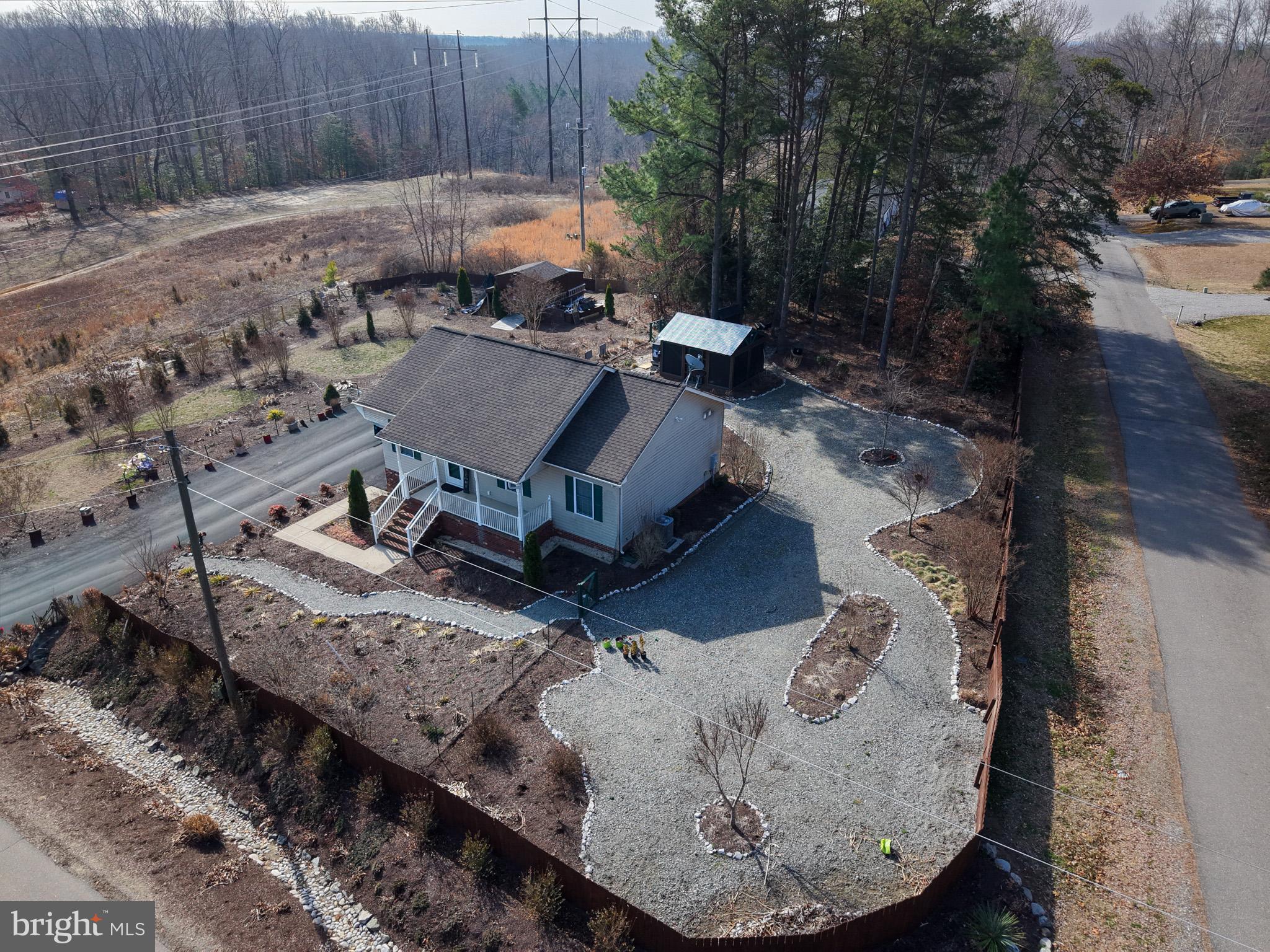 12254 Birkdale Road Ruther Glen, VA 22546 - Photo 54 of 68 a view of a backyard with sitting area