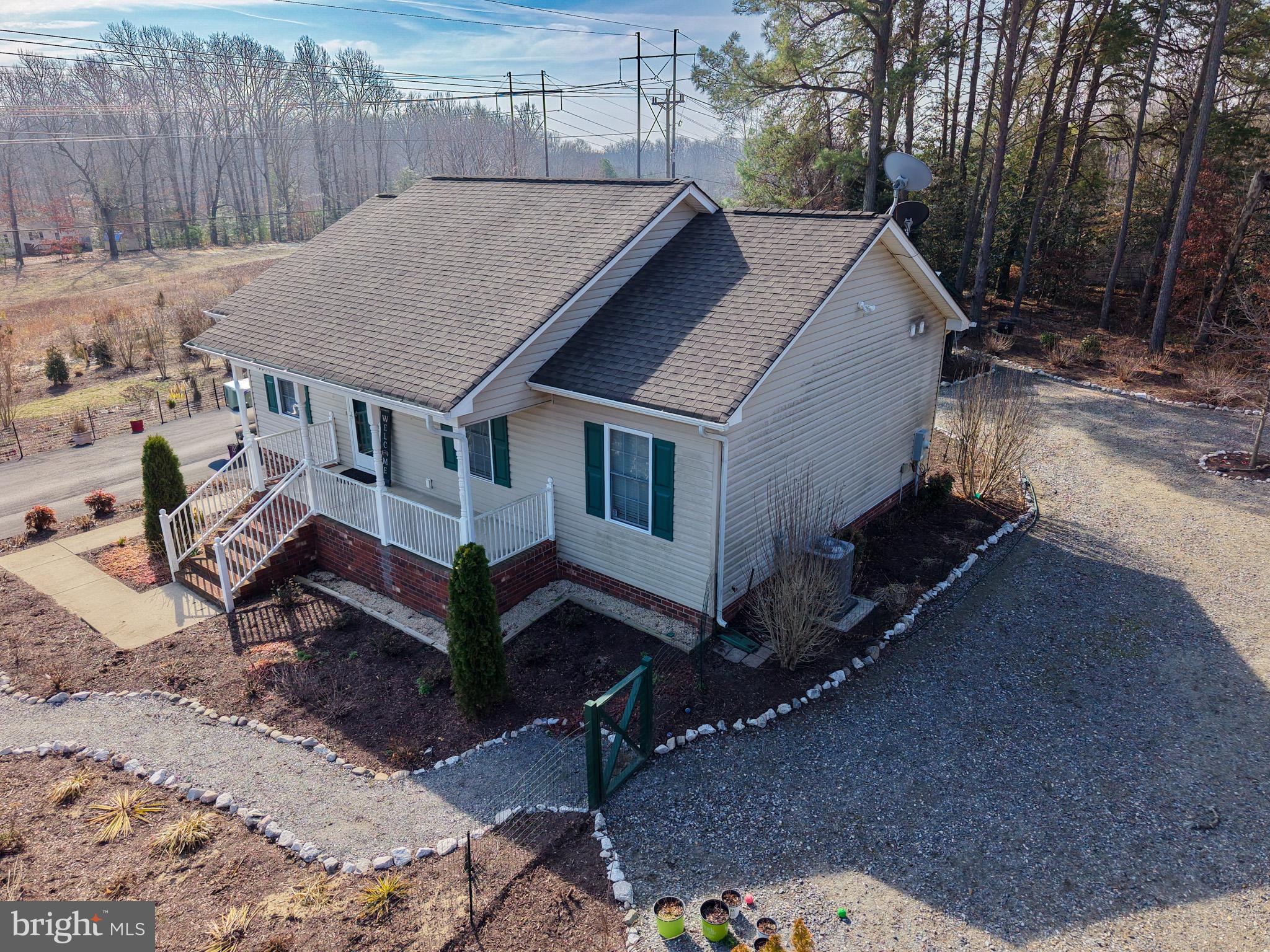 12254 Birkdale Road Ruther Glen, VA 22546 - Photo 55 of 68 a aerial view of a house with a yard and sitting area