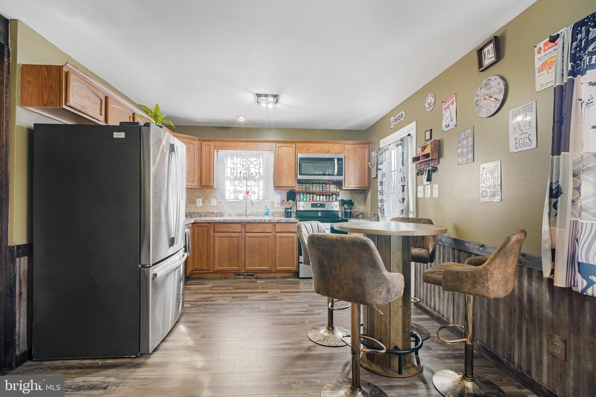 12254 Birkdale Road Ruther Glen, VA 22546 - Photo 6 of 68 a kitchen with stainless steel appliances granite countertop a refrigerator and a stove top oven