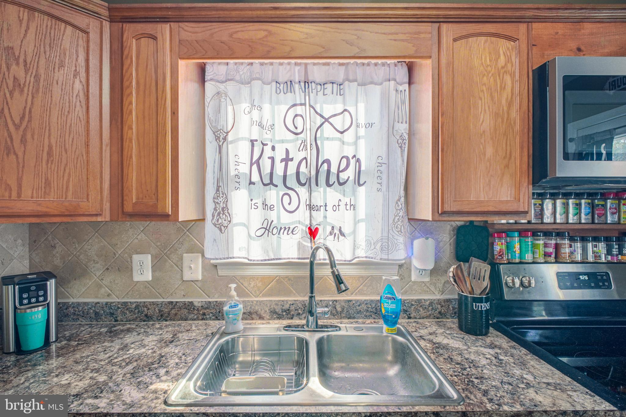 12254 Birkdale Road Ruther Glen, VA 22546 - Photo 10 of 68 a kitchen with a sink and a stove top oven