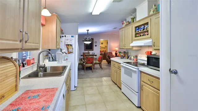 a kitchen with a sink cabinets and window