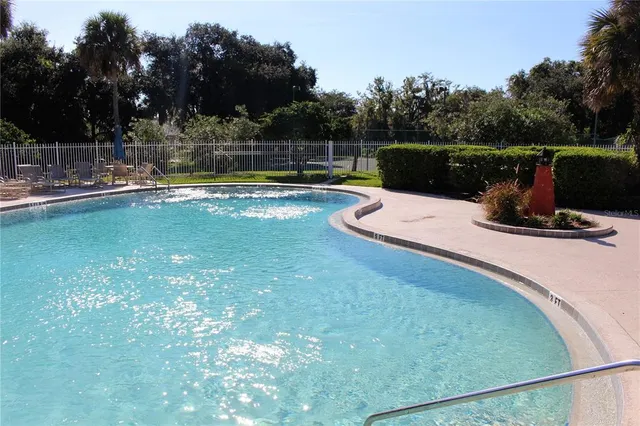 a view of a patio with a table chairs and a fire pit