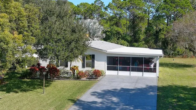 a view of a house with backyard sitting area and garden