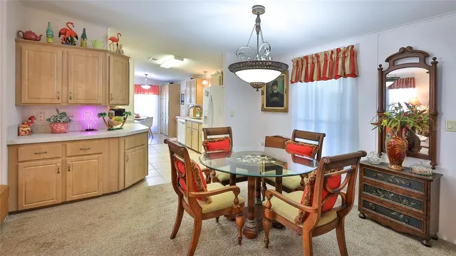 a view of a dining room with furniture and chandelier