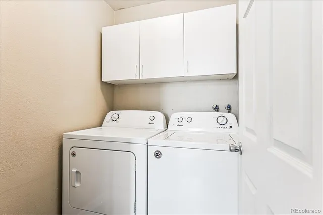 a view of storage and utility room with washer and dryer