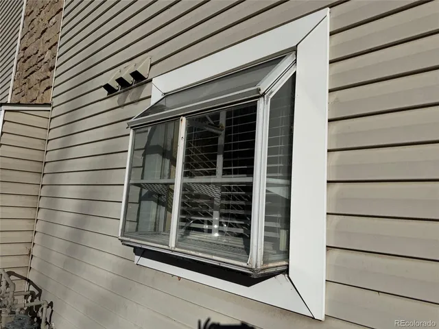 a view of swimming pool with outdoor seating and covered with trees