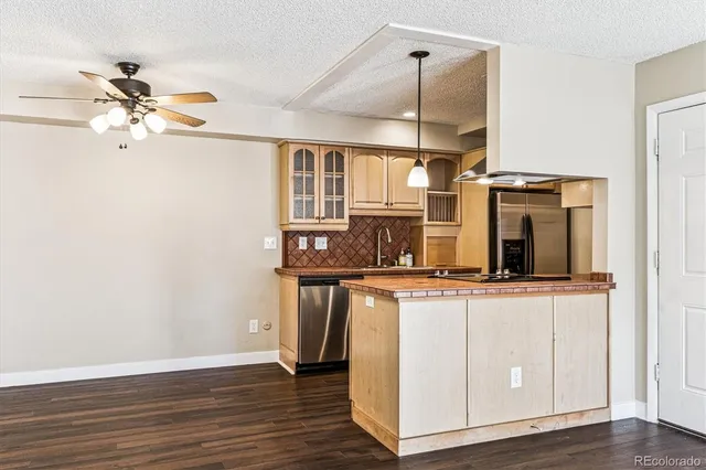 a kitchen with stainless steel appliances granite countertop a sink a stove and cabinets