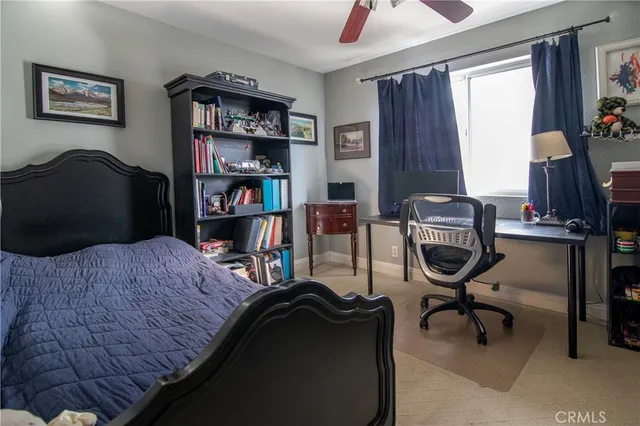 a bathroom with a granite countertop sink a toilet and a mirror