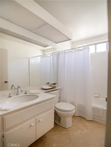 a view of a patio with table and chairs potted plants and large tree