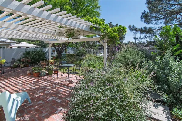 a view of a patio with table and chairs and potted plants
