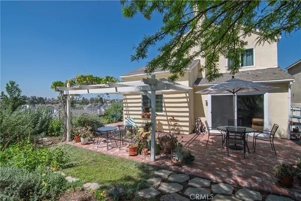 a view of a patio with table and chairs and potted plants