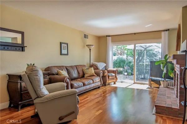 a living room with furniture a fireplace and a large window