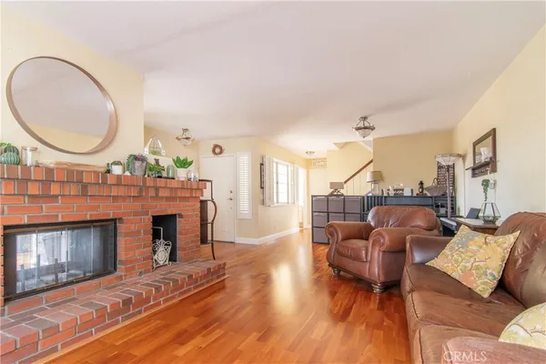 a living room with furniture a large window and a fireplace