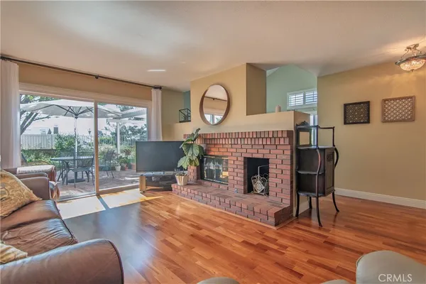a living room with furniture fireplace and wooden floor