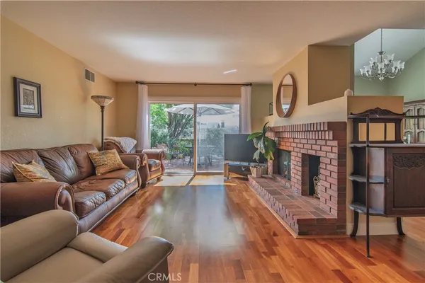 a view of a bedroom with wooden floor