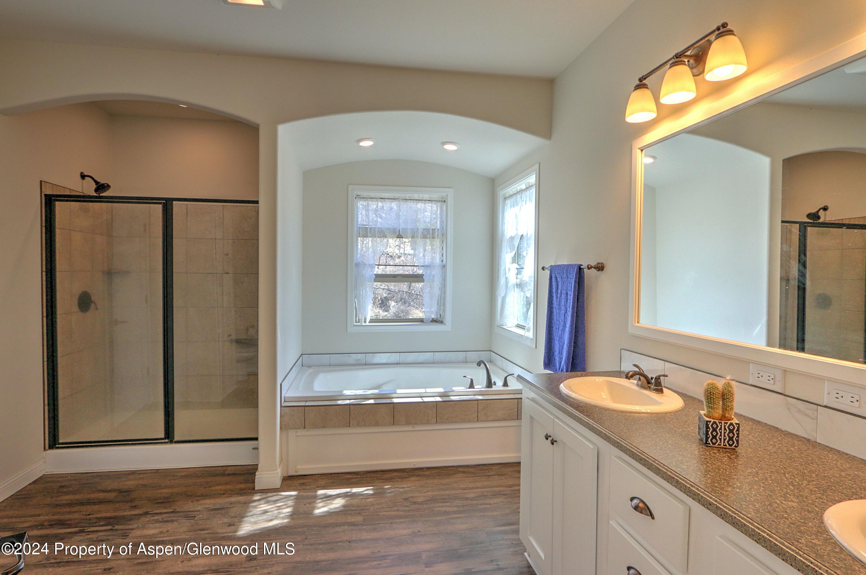 227 Lava Drive El Jebel, CO 81621 - Photo 18 of 38 a spacious bathroom with a tub sink and mirror