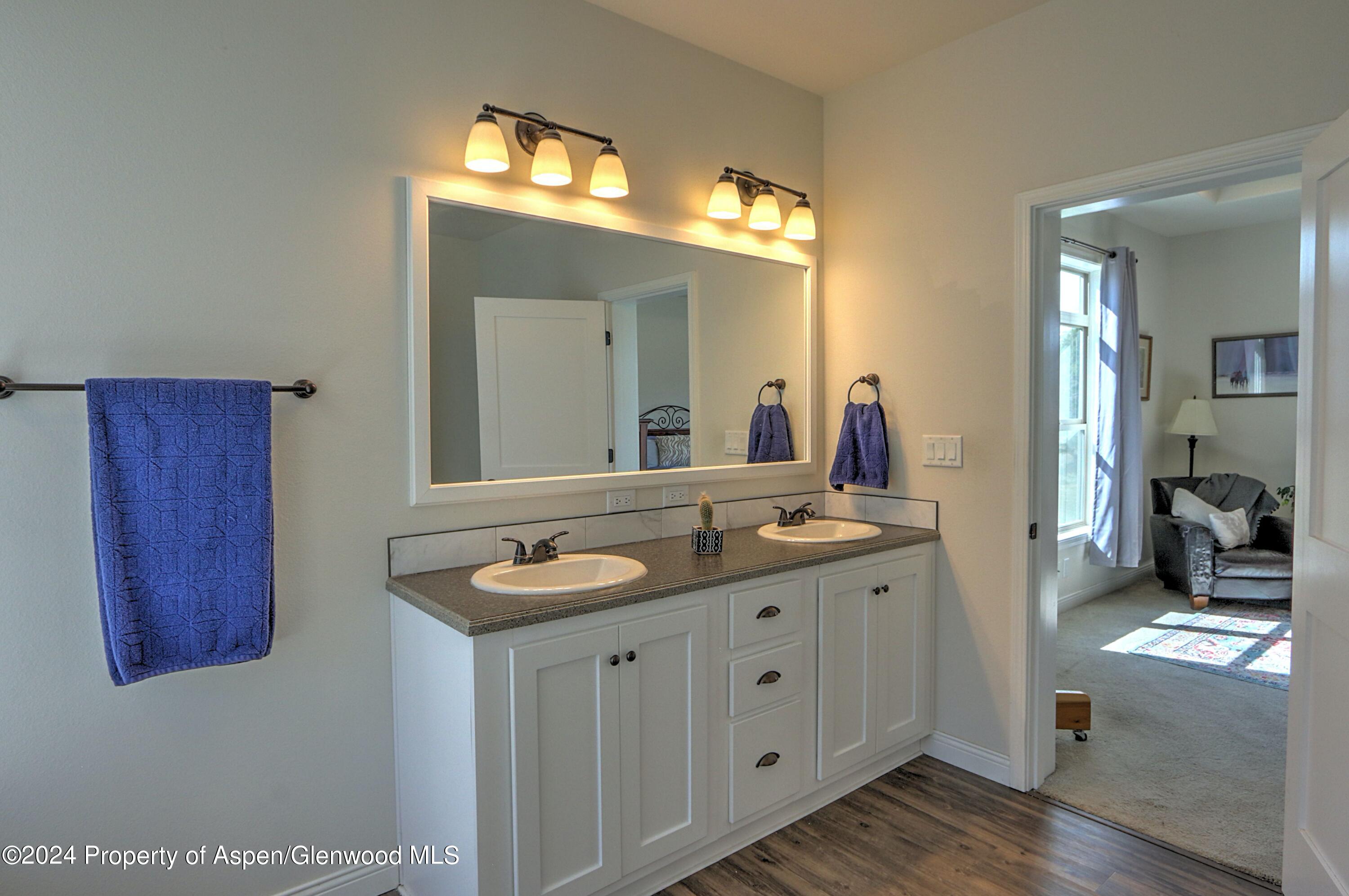 227 Lava Drive El Jebel, CO 81621 - Photo 19 of 38 a en suite bathroom with a granite countertop sink and a mirror