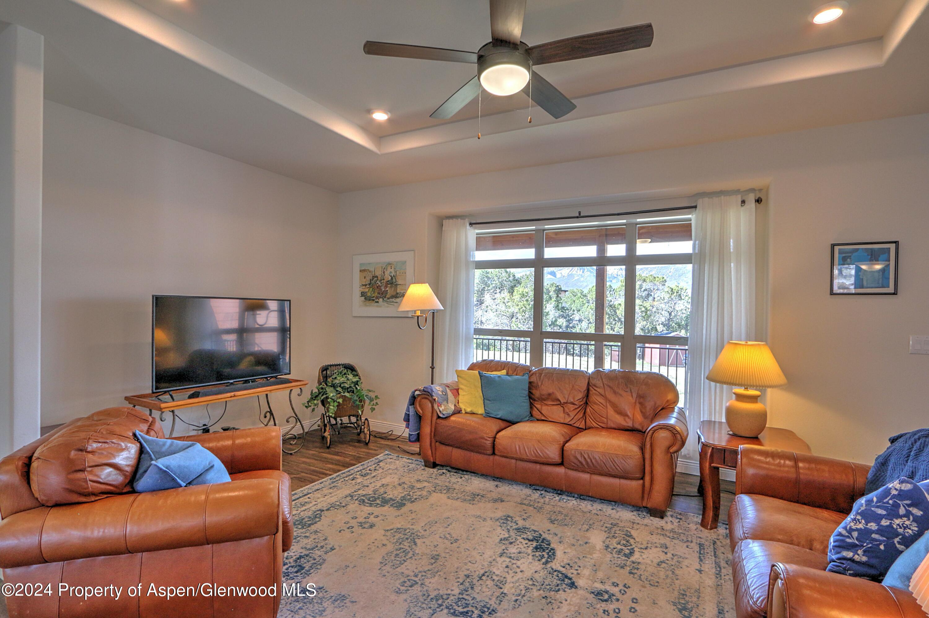 227 Lava Drive El Jebel, CO 81621 - Photo 5 of 38 a living room with furniture and a flat screen tv