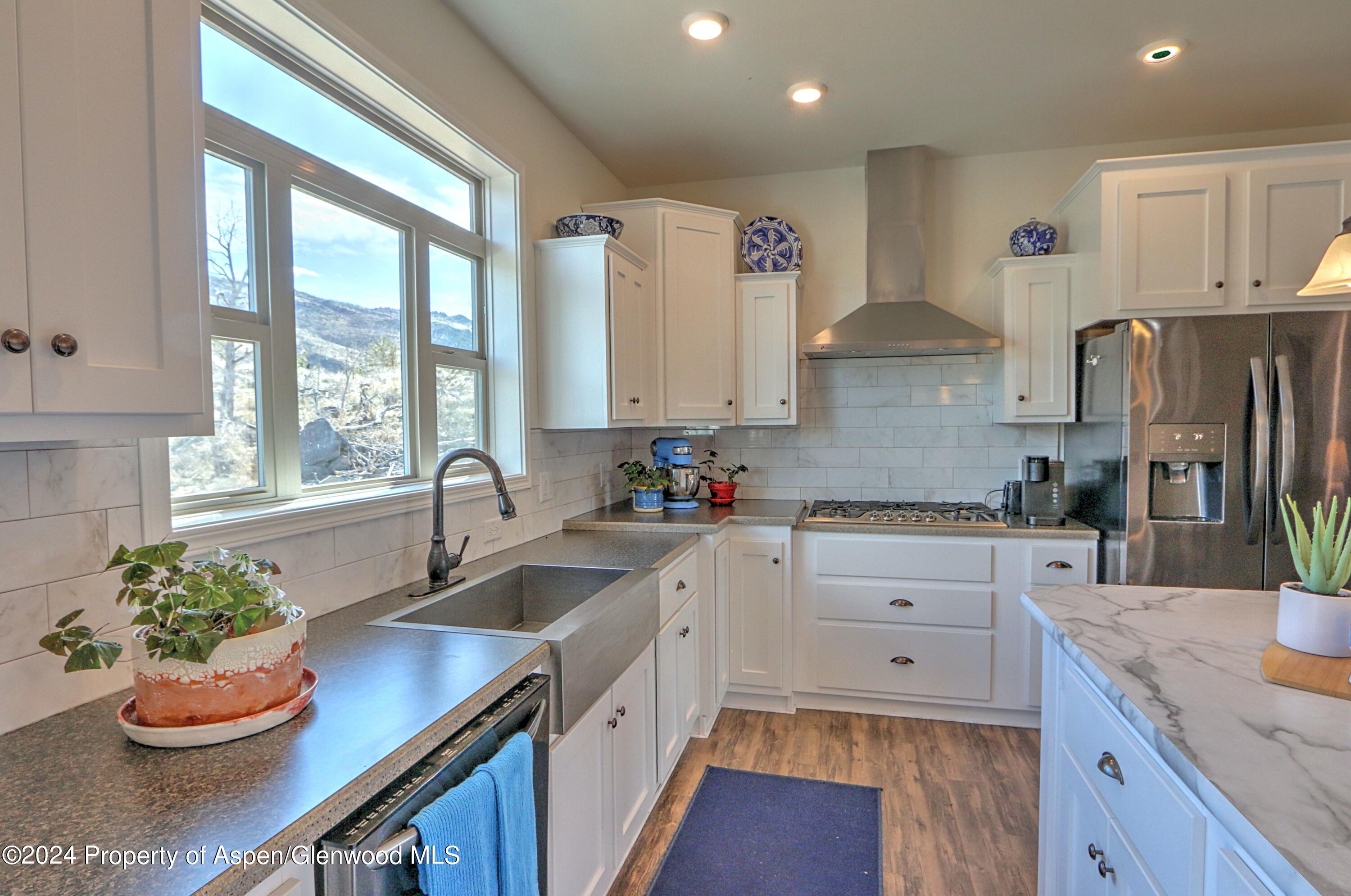227 Lava Drive El Jebel, CO 81621 - Photo 7 of 38 a kitchen with a sink stove and cabinets