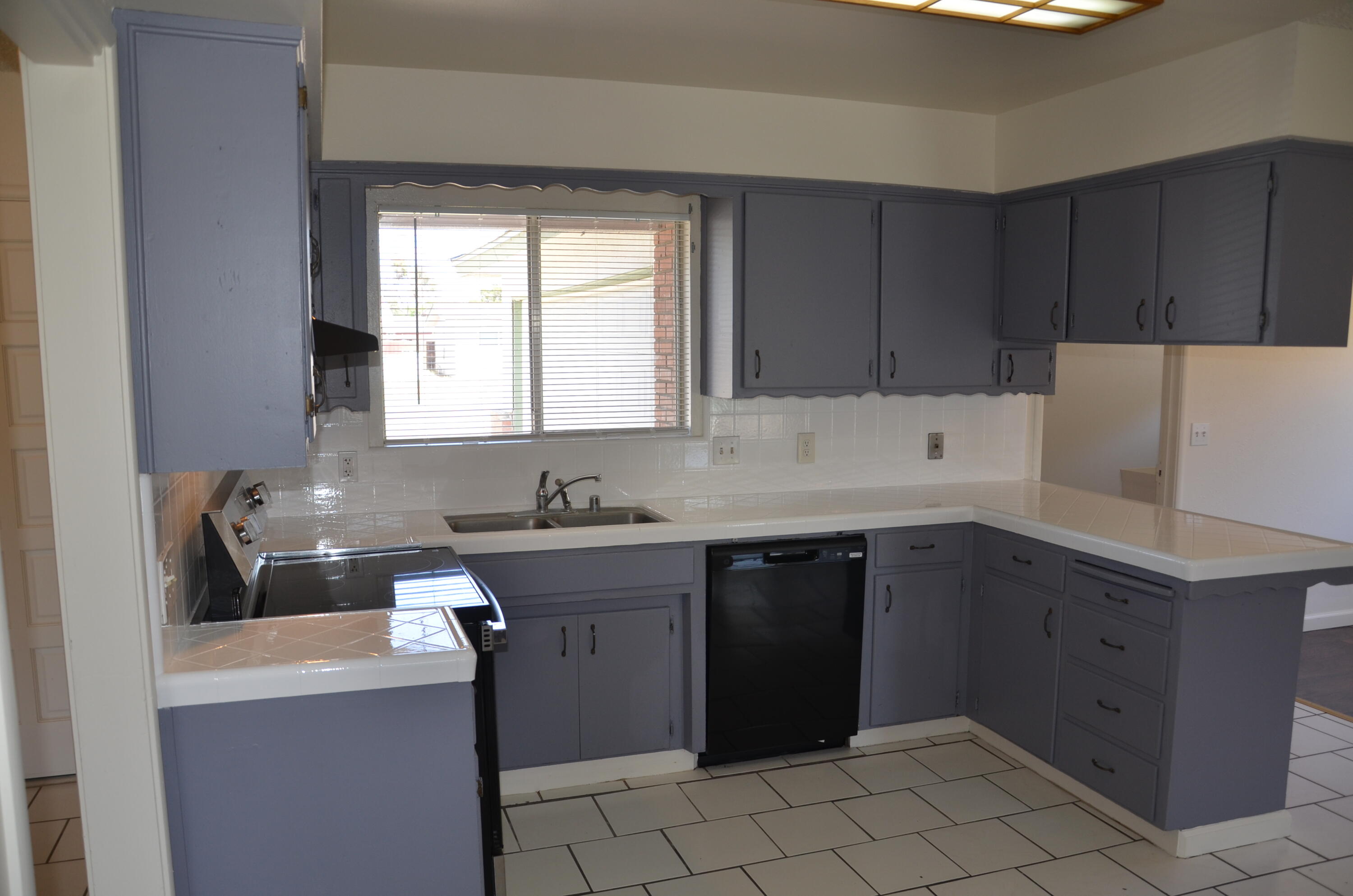 339 West Spring Lane Lemoore, CA 93245 - Photo 2 of 31 a kitchen with a sink window and cabinets