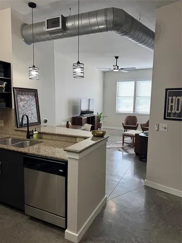 a kitchen with a sink and a stove top oven
