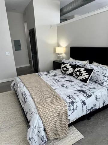 a bedroom with a bed and a mirror