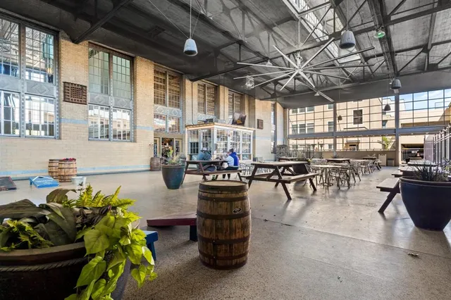 a lobby with furniture and potted plants