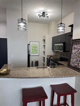 a kitchen with a counter space a sink and appliances