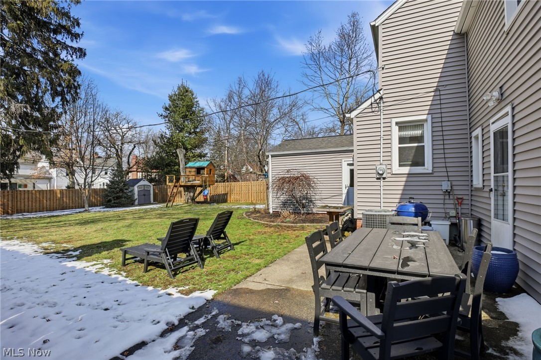1390 Brainard Road Lyndhurst, OH 44124 - Photo 29 of 33 Fenced backyard featuring a patio area, a shed, a playground, and outdoor dining area
