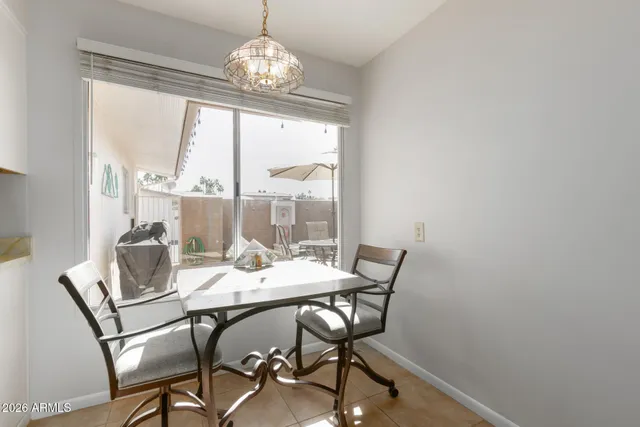 a view of a dining room with furniture wooden floor and chandelier