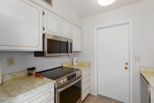 a kitchen with a stove and a microwave