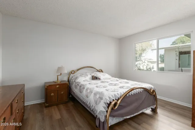 a bed sitting in a bedroom next to a window