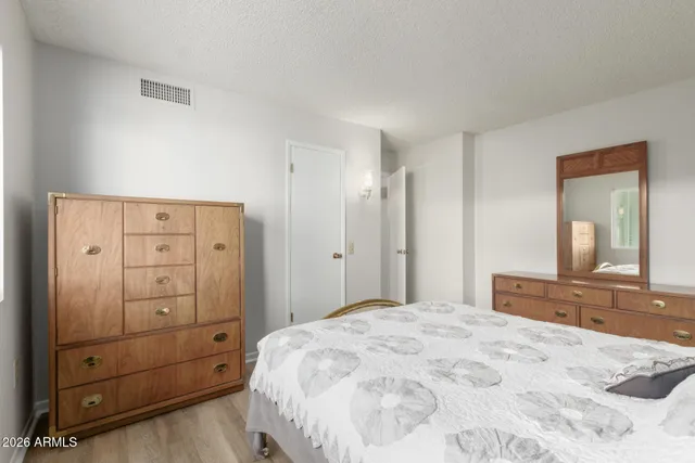 a bedroom with a bed and a dresser