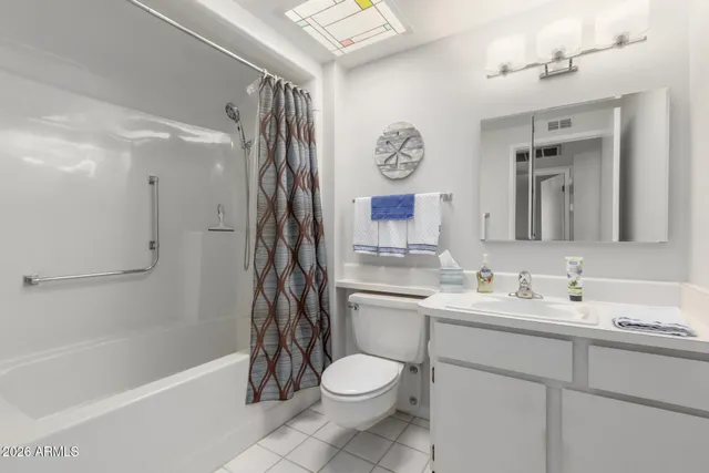 a bathroom with a toilet sink and shower