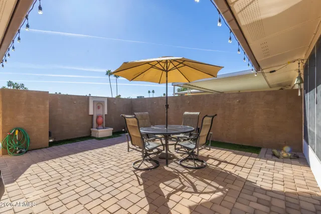 a patio with a table and chairs