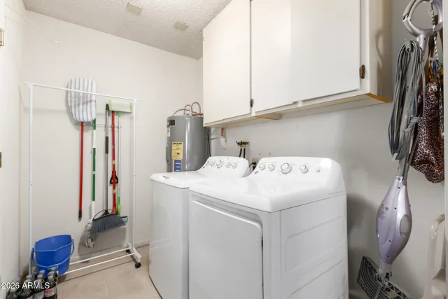 a view of walk in closet with clothes washer and dryer